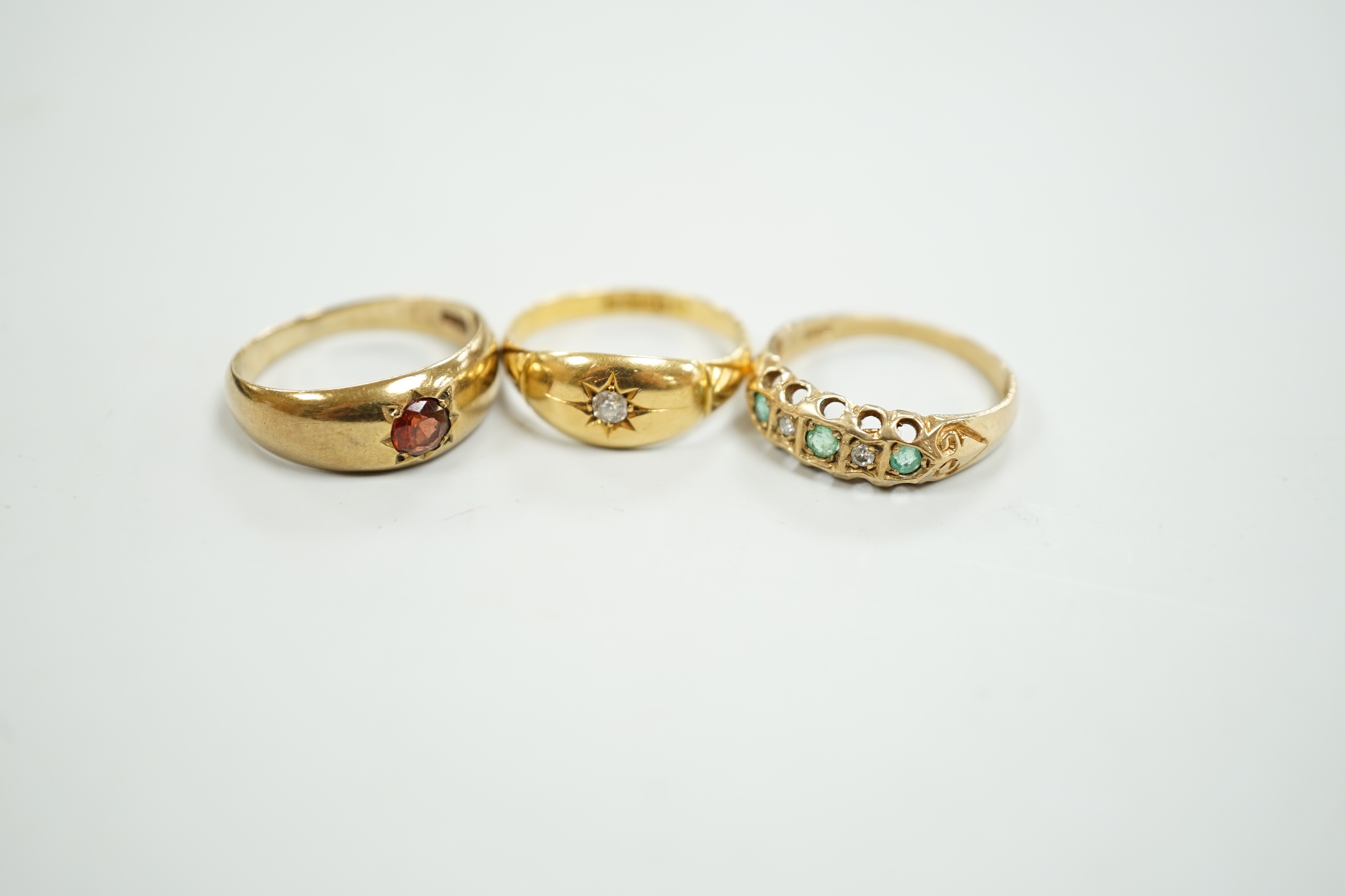 An Edwardian 18ct gold and diamond chip set ring, size M, gross weight 2.6 grams and two later 9ct gold and gem set rings, gross weight 5.5 grams.